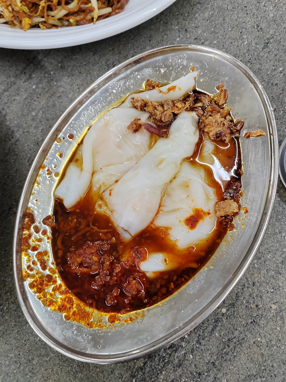 Chee cheong fun in pooled chilli sauce with fried shallots